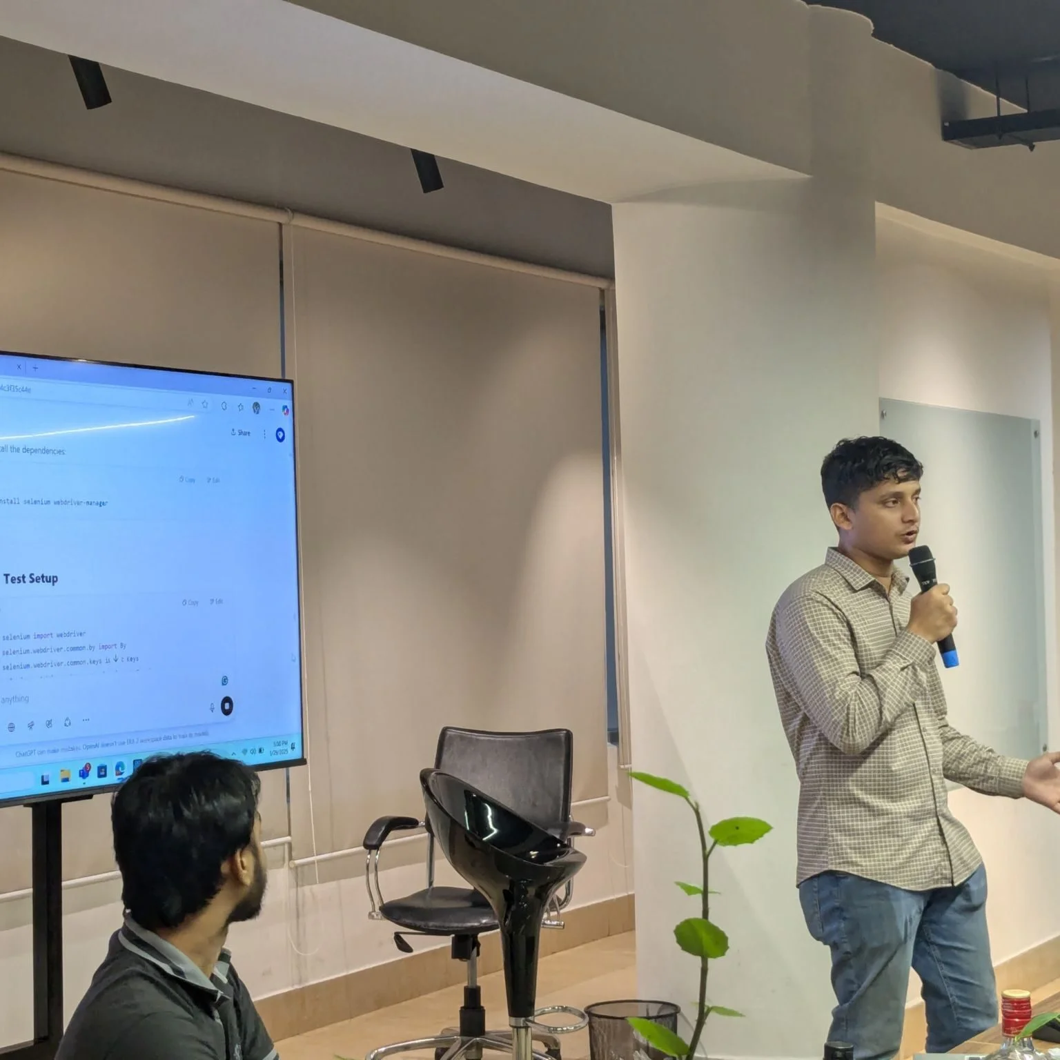 Noor E Arafin Rafi giving a talk in front of a presentation screen